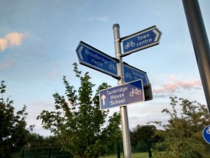 Direction signs and route confirmatory signs on same post